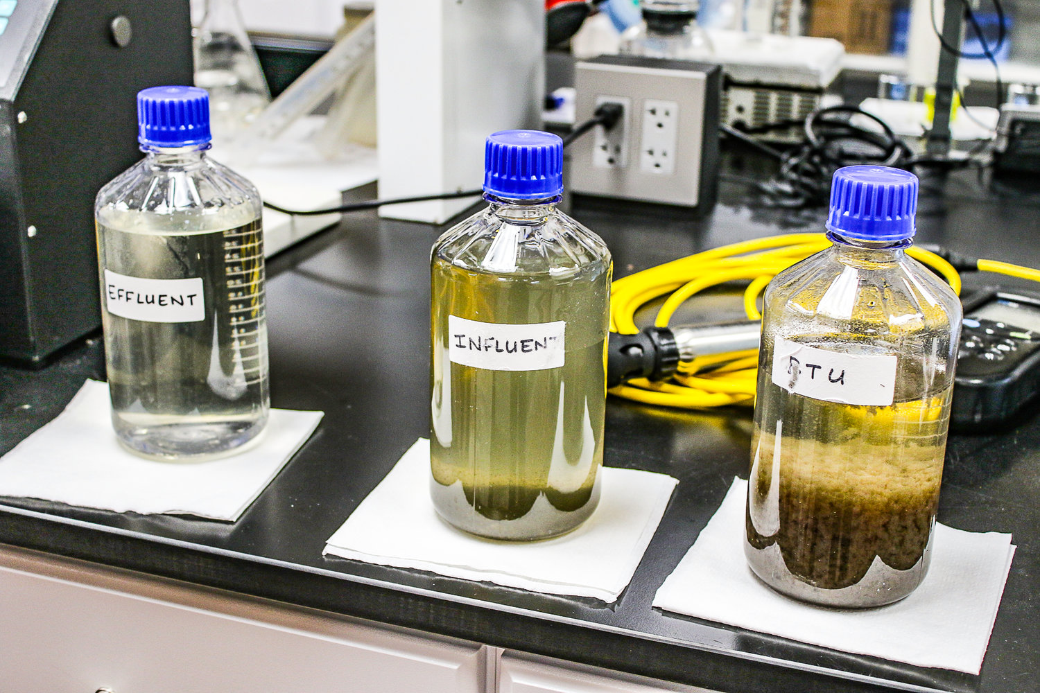 Curmode showed examples of stages of treatment in the on-site laboratory. At right, BTU or Biological Treatment Units, in the form of bacteria are mixed with waste water. Center, Influent is the waste water as it come in to the plant. Left, Effluent is what is released into the waterway.